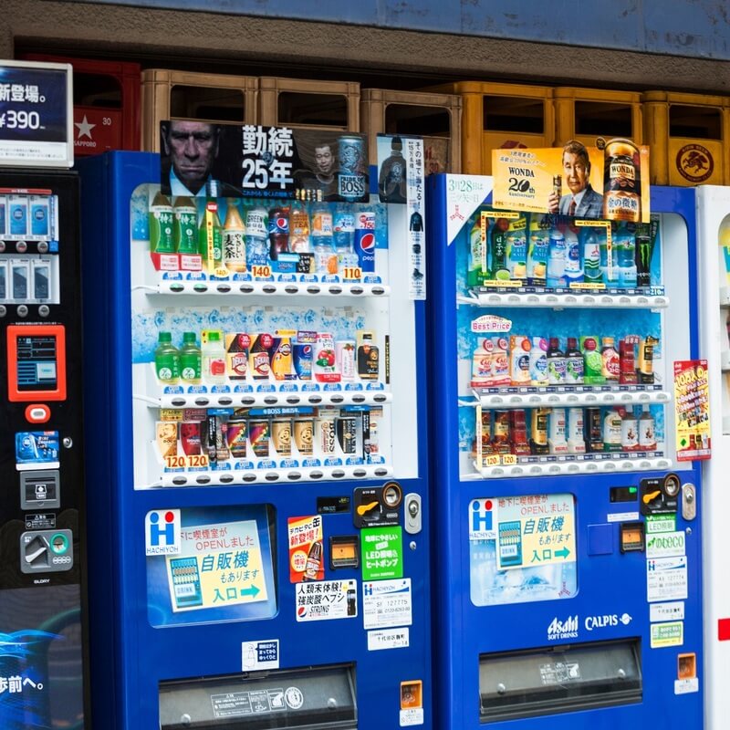 3 vending machines with different products being sold.